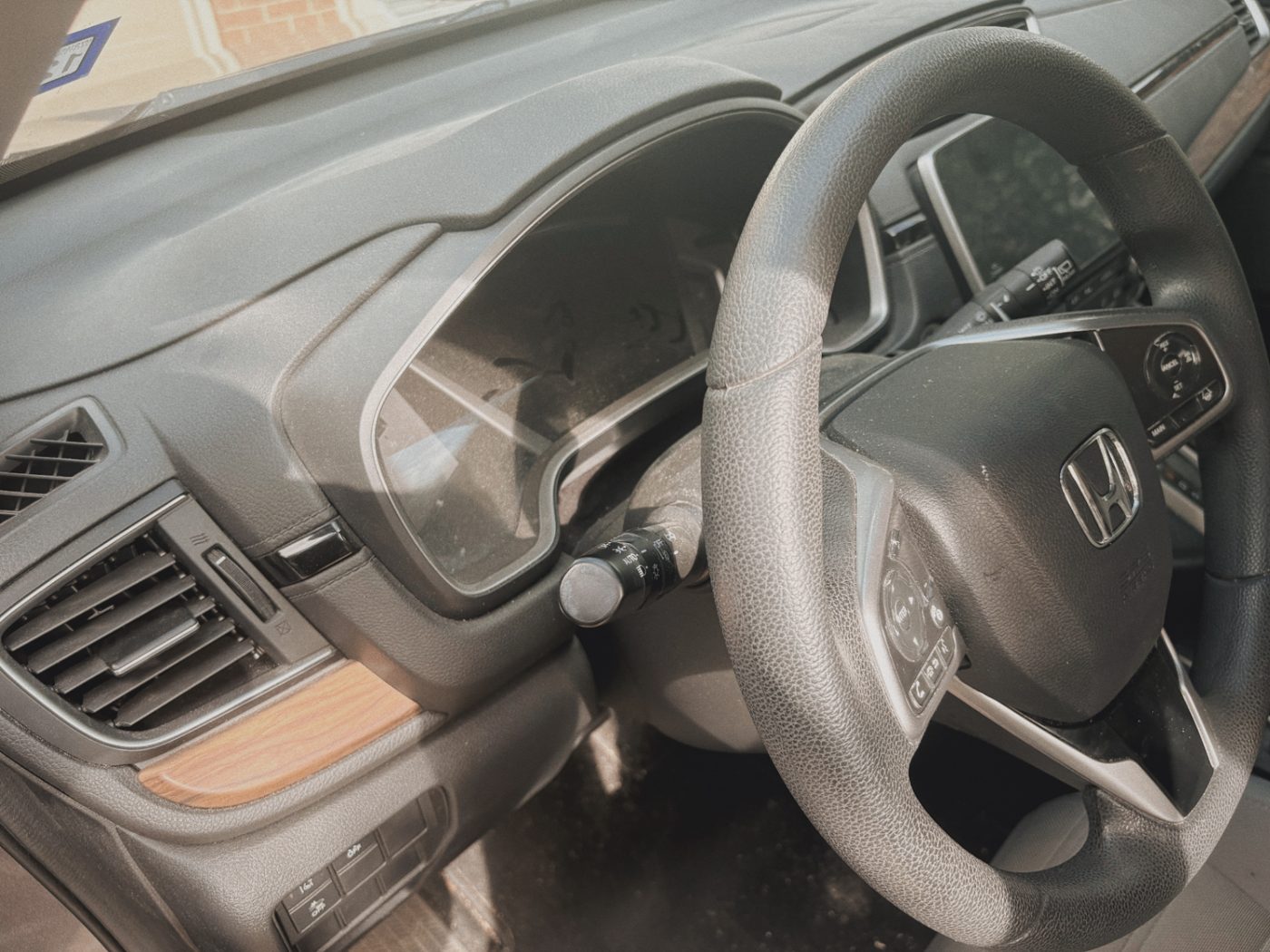 Honda CR-V dusty dashboard and steering wheel before detailing